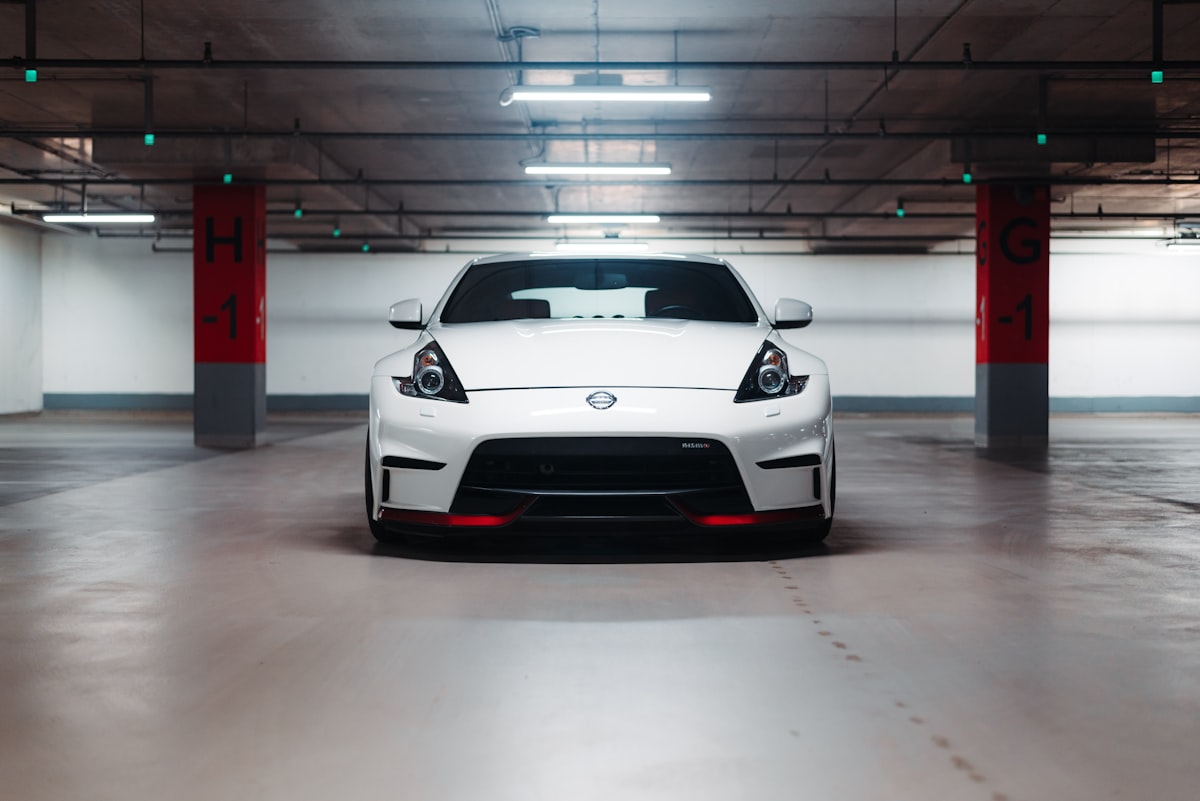a white sports car parked in a parking garage